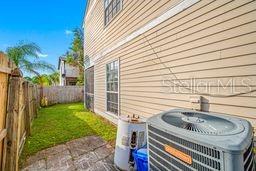 exterior space with a fenced backyard and central AC