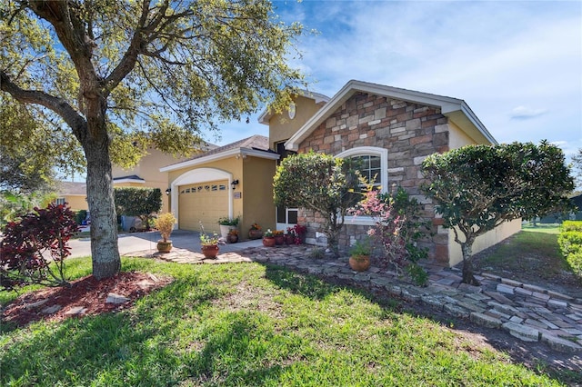 view of front of property featuring concrete driveway, stone siding, an attached garage, a front lawn, and stucco siding