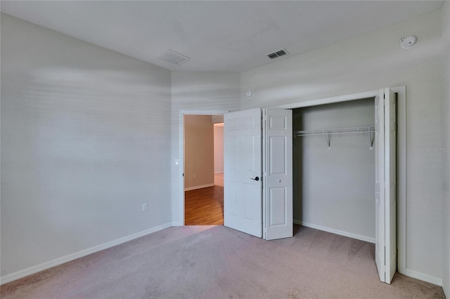 unfurnished bedroom featuring carpet floors, visible vents, and baseboards