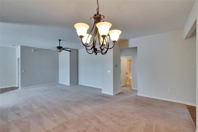 empty room with baseboards, a ceiling fan, and light colored carpet