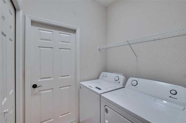 clothes washing area with washer and dryer and laundry area