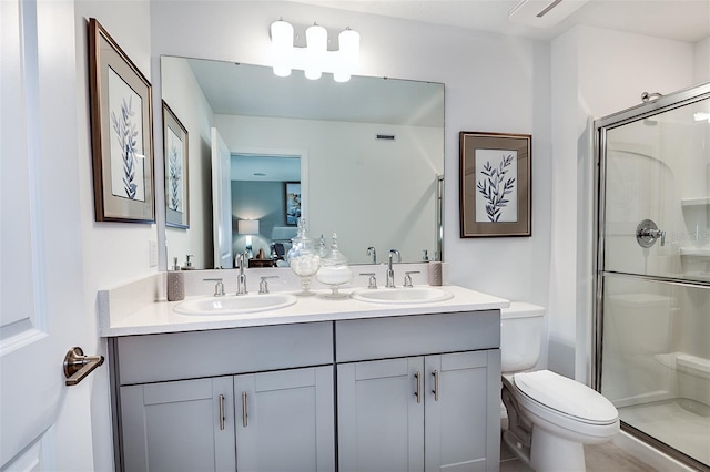 bathroom featuring connected bathroom, a stall shower, a sink, and toilet