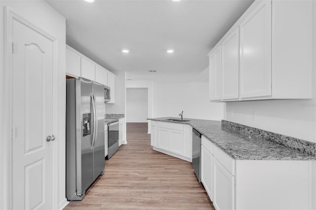 2674 SW 165th Street Rd, Ocala, FL 34473 - kitchen featuring stainless steel appliances, white cabinets, recessed lighting, a sink, and light wood finished floors