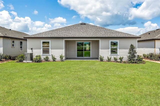 2674 SW 165th Street Rd, Ocala, FL 34473 - rear view of house featuring a yard, a shingled roof, and cooling unit