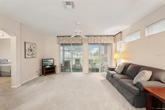 living area featuring carpet flooring, baseboards, visible vents, and ceiling fan