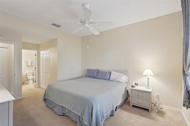 bedroom with baseboards, visible vents, a closet, light carpet, and connected bathroom