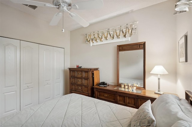 bedroom with a ceiling fan, visible vents, and a closet