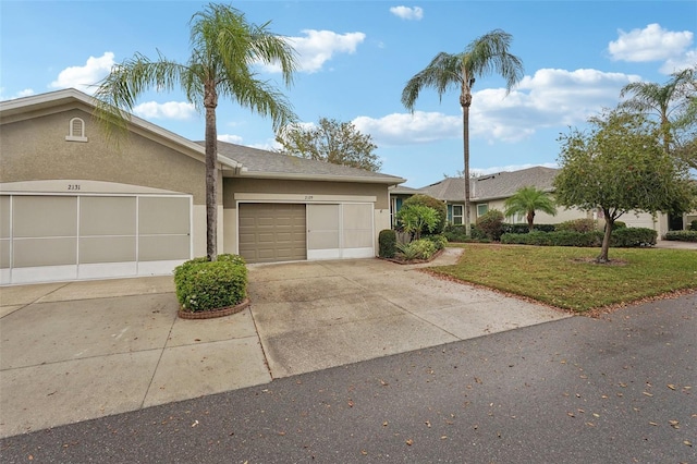 view of front facade featuring stucco siding, concrete driveway, a front lawn, and a garage