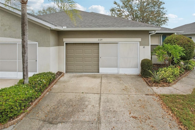 garage with concrete driveway