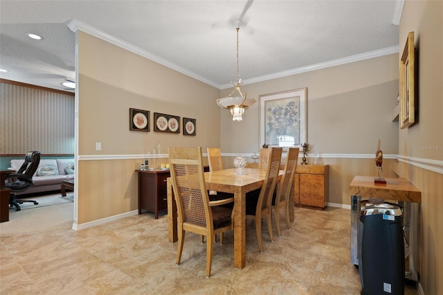 3798 Darston St, Palm Harbor, FL 34685 - dining space featuring a wainscoted wall, crown molding, and a textured ceiling