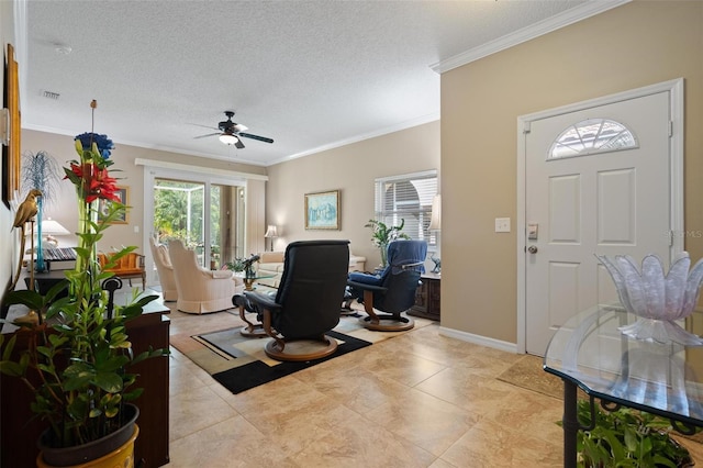 3798 Darston St, Palm Harbor, FL 34685 - entrance foyer featuring crown molding, visible vents, ceiling fan, a textured ceiling, and baseboards