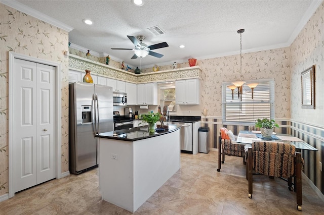 3798 Darston St, Palm Harbor, FL 34685 - kitchen featuring stainless steel appliances, visible vents, ornamental molding, a center island, and wallpapered walls
