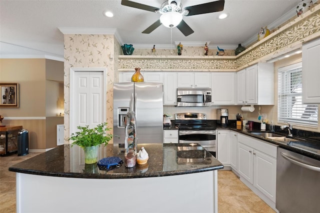 3798 Darston St, Palm Harbor, FL 34685 - kitchen with crown molding, appliances with stainless steel finishes, a sink, and wainscoting