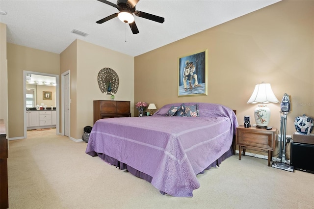 3798 Darston St, Palm Harbor, FL 34685 - carpeted bedroom featuring a ceiling fan, baseboards, visible vents, and ensuite bath