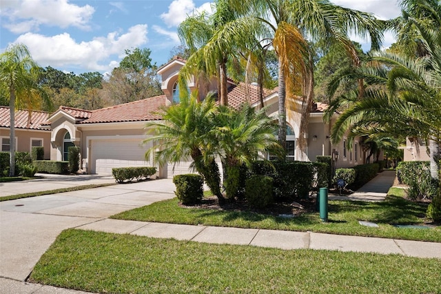 3798 Darston St, Palm Harbor, FL 34685 - mediterranean / spanish-style house featuring stucco siding, concrete driveway, an attached garage, a tiled roof, and a front lawn