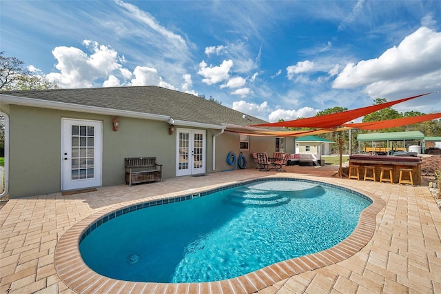 pool featuring a patio and french doors