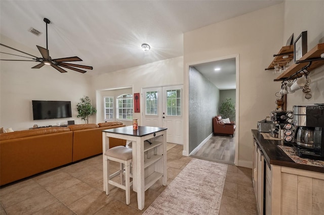 kitchen with french doors, open shelves, dark countertops, visible vents, and baseboards