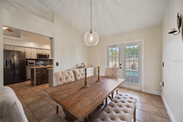 dining room featuring lofted ceiling, a toaster, french doors, and baseboards