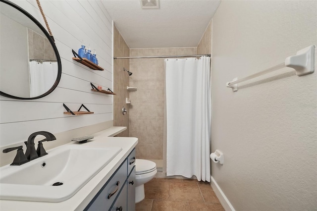 bathroom with toilet, wood walls, visible vents, vanity, and a tile shower