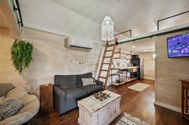 living room featuring a barn door, wooden walls, wood-type flooring, and a wall mounted air conditioner