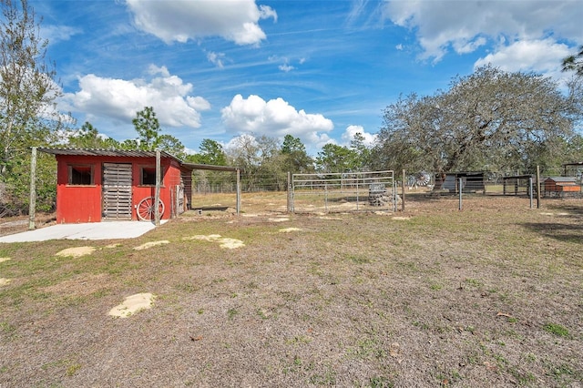 view of yard featuring an outbuilding, a pole building, and fence