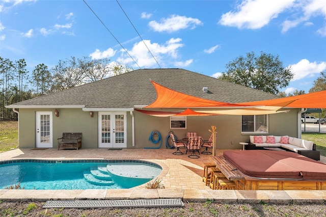 back of house with a patio area, roof with shingles, stucco siding, and french doors