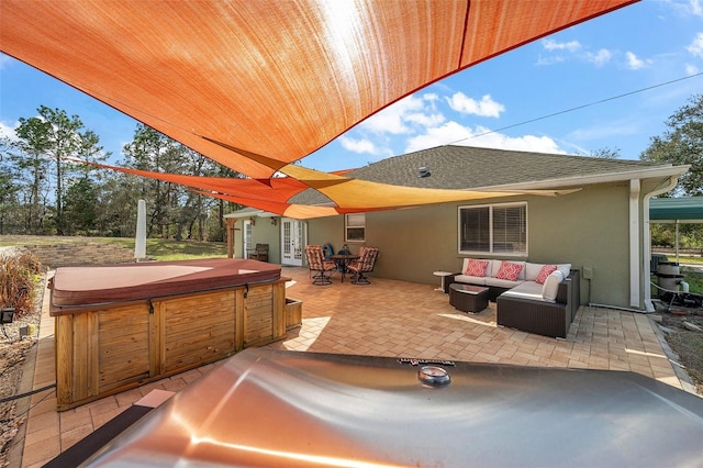 view of patio with a hot tub, an outdoor hangout area, and french doors