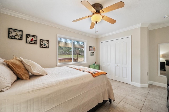 bedroom featuring light tile patterned floors, baseboards, a ceiling fan, crown molding, and a closet