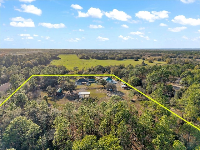 birds eye view of property with a rural view and a wooded view