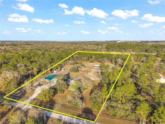 drone / aerial view with a view of trees