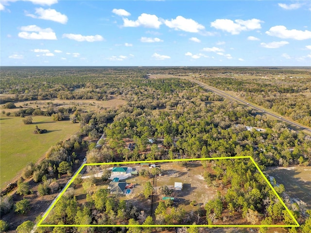 drone / aerial view featuring a view of trees