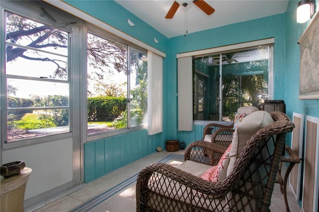 sunroom / solarium featuring a ceiling fan and plenty of natural light