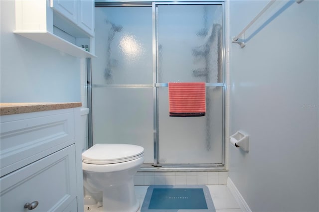 bathroom with a stall shower, tile patterned flooring, and toilet