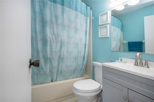 bathroom with shower / bath combination with curtain, vanity, and toilet