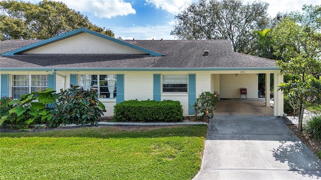 ranch-style house featuring an attached carport, brick siding, a shingled roof, driveway, and a front yard