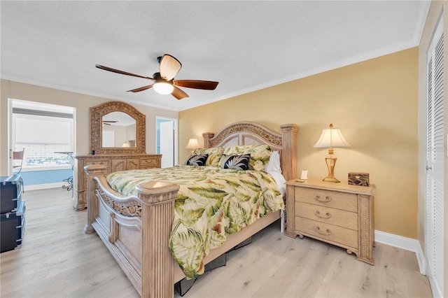 bedroom with light wood finished floors, baseboards, and ornamental molding