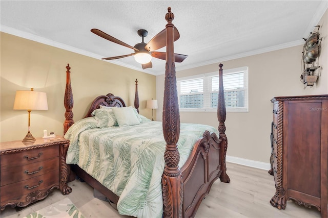 bedroom featuring a textured ceiling, a ceiling fan, baseboards, ornamental molding, and light wood-type flooring