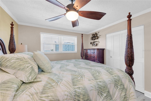 bedroom featuring a textured ceiling, ornamental molding, and a closet