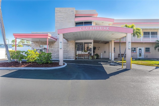 view of building exterior featuring uncovered parking