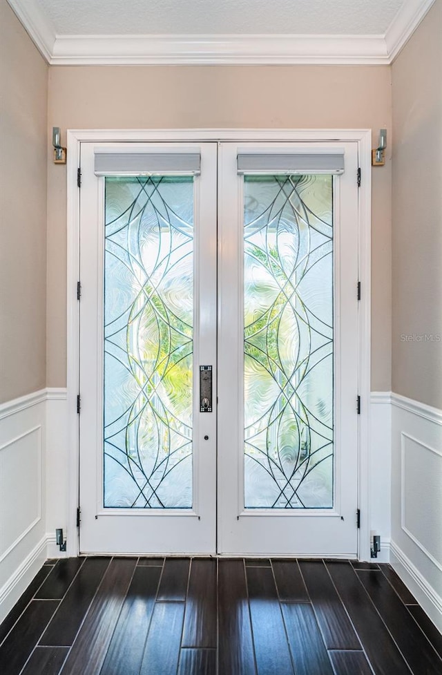 doorway to outside featuring ornamental molding, french doors, dark wood-style flooring, and wainscoting