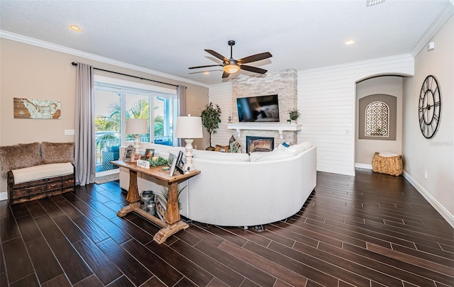 living room featuring ornamental molding, wood finish floors, and a fireplace