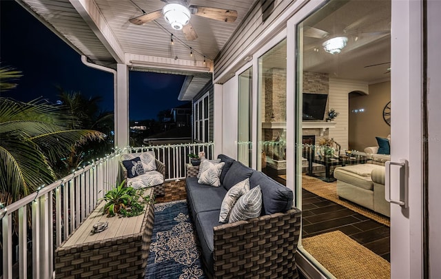 balcony with ceiling fan and an outdoor living space