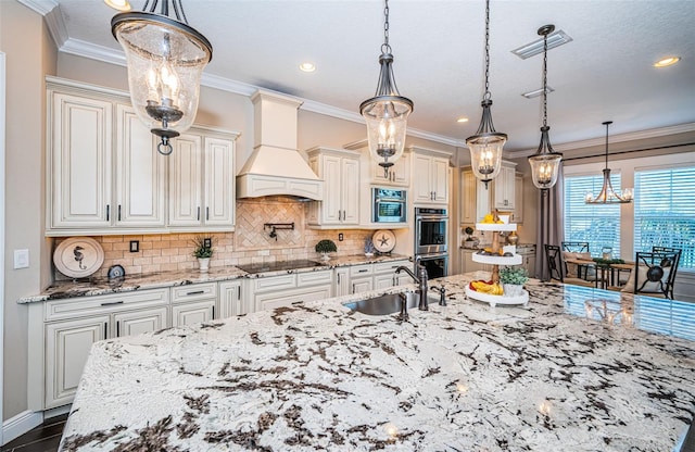 kitchen with ornamental molding, black electric cooktop, stainless steel double oven, premium range hood, and a sink