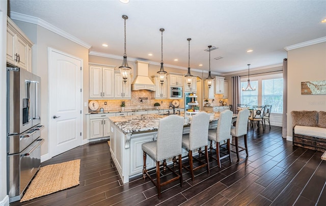 kitchen with stainless steel appliances, decorative backsplash, custom exhaust hood, and wood tiled floor