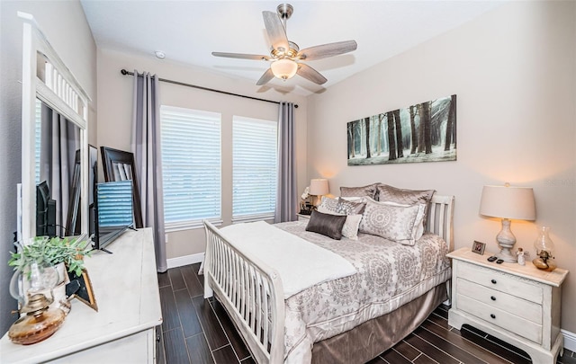 bedroom featuring wood finish floors, ceiling fan, and baseboards