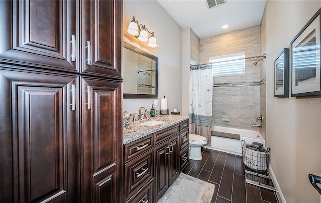 full bath featuring visible vents, toilet, shower / bath combo with shower curtain, wood tiled floor, and vanity