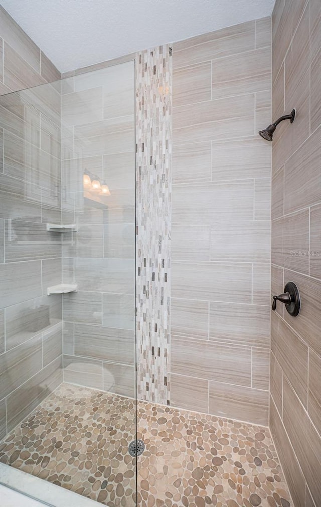 full bathroom with a tile shower