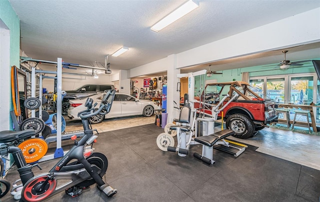 gym with a garage and a textured ceiling