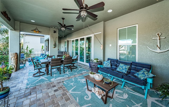 view of patio / terrace featuring outdoor dining space, outdoor lounge area, and a ceiling fan