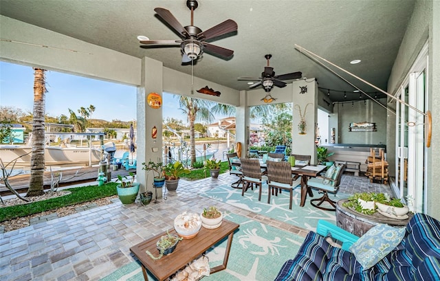 view of patio / terrace with outdoor dining space and a ceiling fan